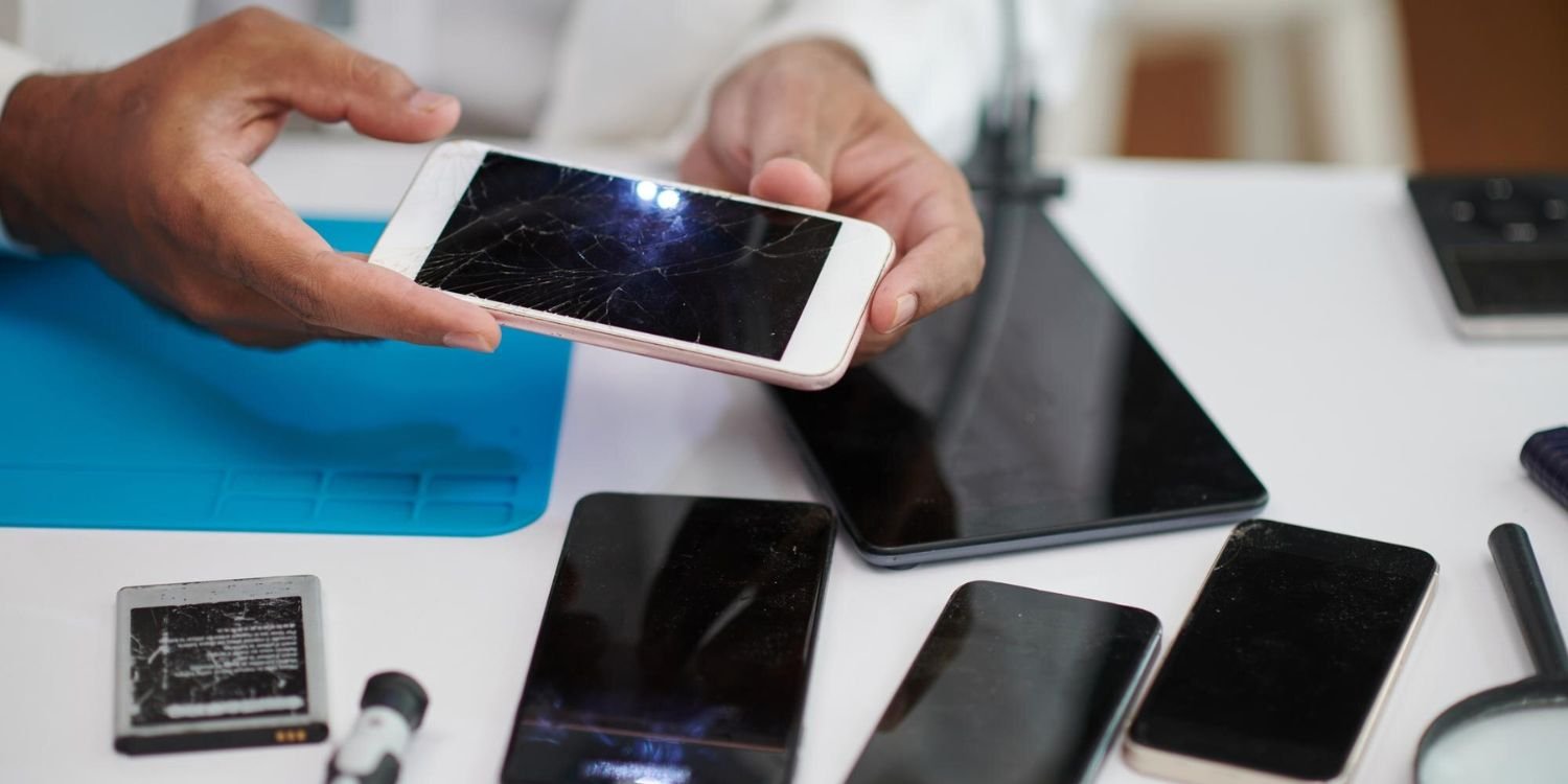 hands of technician replacing broken smartphone screen
